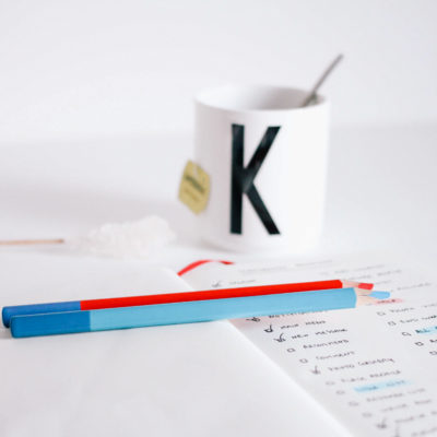 Photo of a to do list written in a book next to a hot drink on a desk, used in a blog post regarding Phoebe Netto's top productivity hacks for business owners. Read more great business tips from the Boutique PR agency in Sydney, Good Business Consulting.