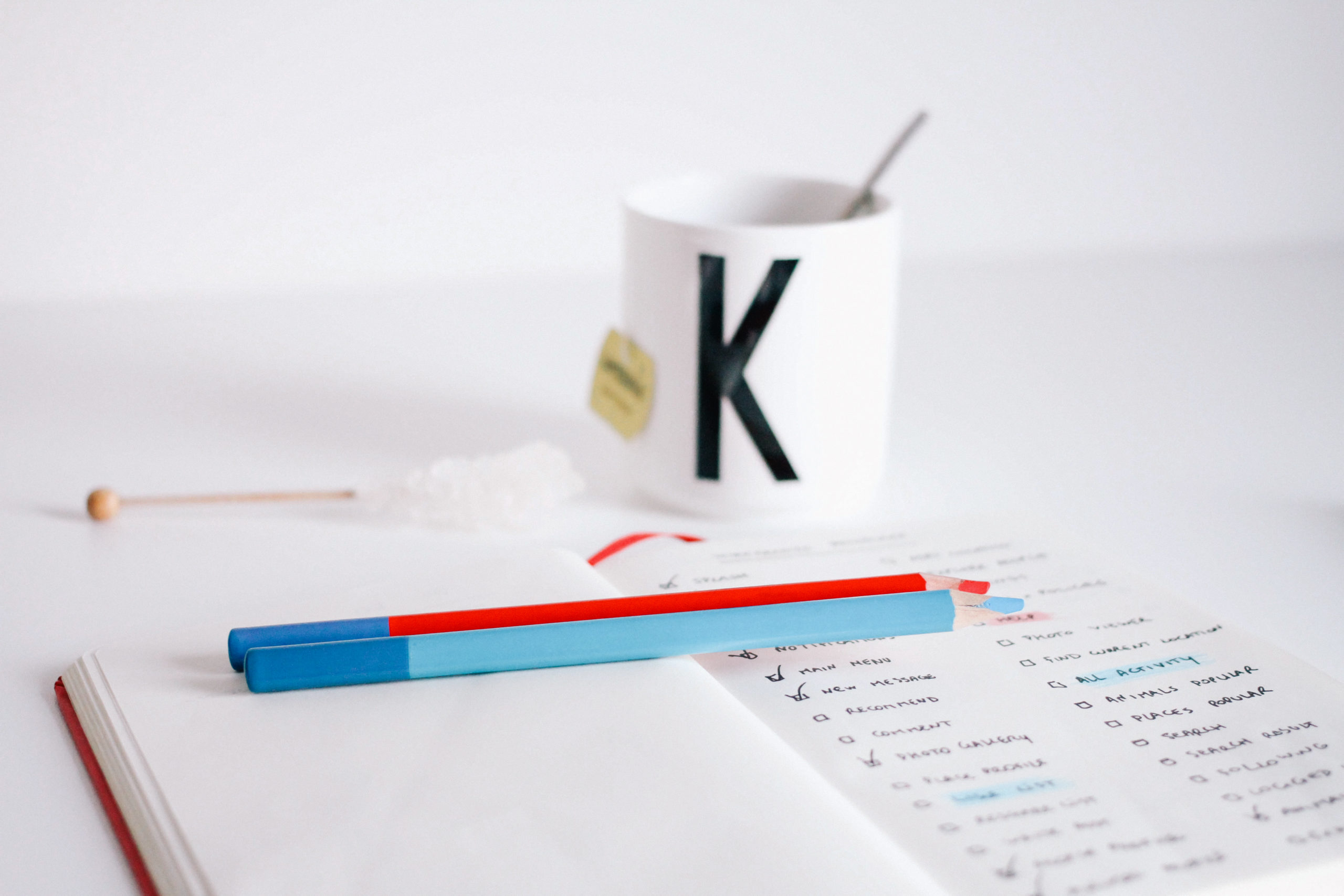 Photo of a to do list written in a book next to a hot drink on a desk, used in a blog post regarding Phoebe Netto's top productivity hacks for business owners. Read more great business tips from the Boutique PR agency in Sydney, Good Business Consulting.