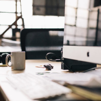 Photo of a work desk with computer screen and coffee mug, used in a blog post regarding making a habit of regularly generating new business and filling the sales pipeline for small business, written by Phoebe Netto, founder of Good Business Consulting , a PR Firm from Sydney.