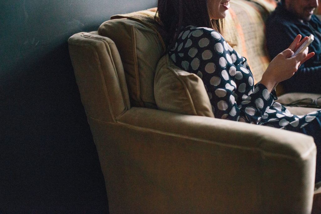 Photo of a couple reading media outlets on the couch. This image is used in a blog post by Good Business Consulting, a PR firm in Sydney, with advice on how to woo media targets with your more compelling business stories.