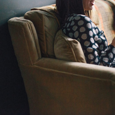 Photo of a couple reading media outlets on the couch. This image is used in a blog post by Good Business Consulting, a PR firm in Sydney, with advice on how to woo media targets with your more compelling business stories.