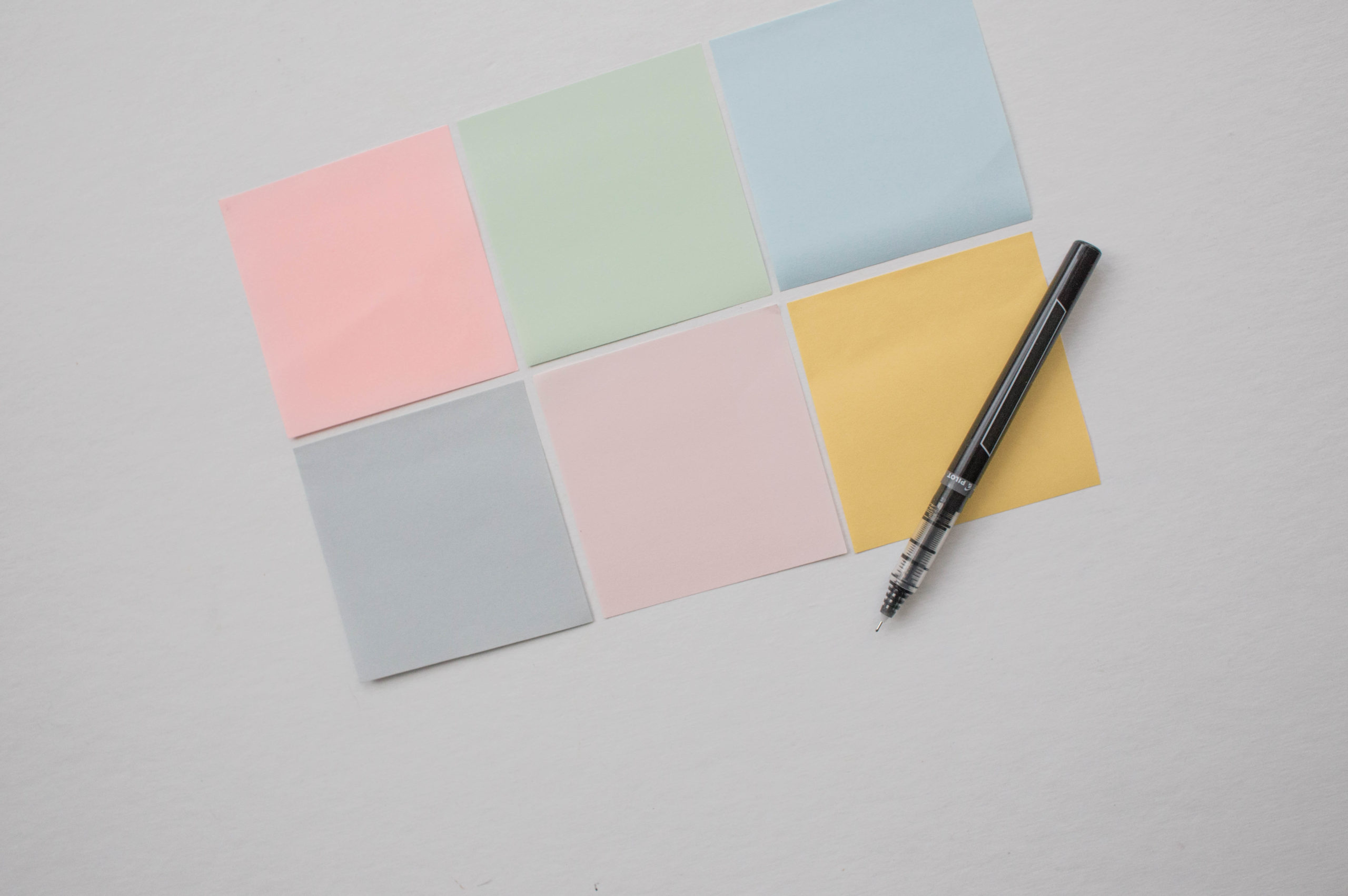 Post-it notes and pen used to brainstorm types of media outlets to include on a PR media list. This article from Good Business Consulting gives you guidelines for identifying which media to target.